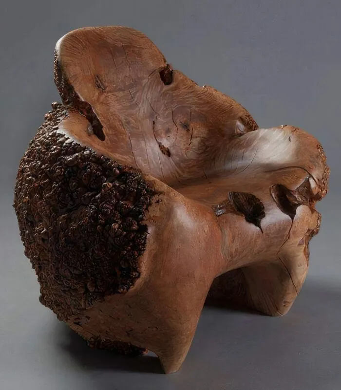 A hand-carved solid tree trunk armchair representing clever wooden creations.