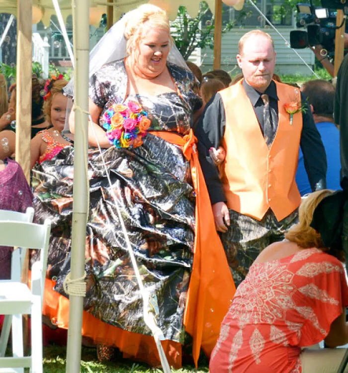 Bride in a camouflage gown and orange sash at questionable wedding moments