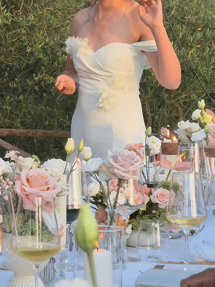 A close-up of a bride in her wedding dress at a dinner table representing questionable wedding moments