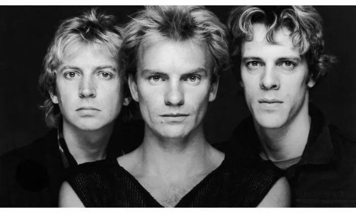 Black and white 70s portrait of three men close together