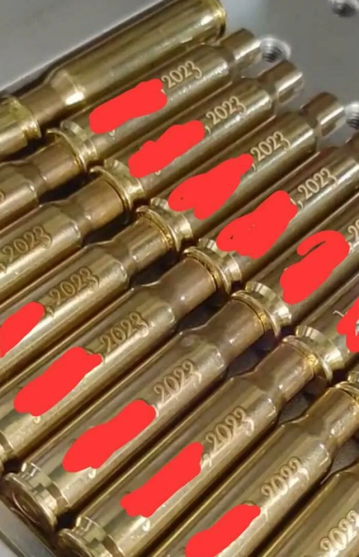 Gold bullet casings engraved with 2023 at questionable wedding moments