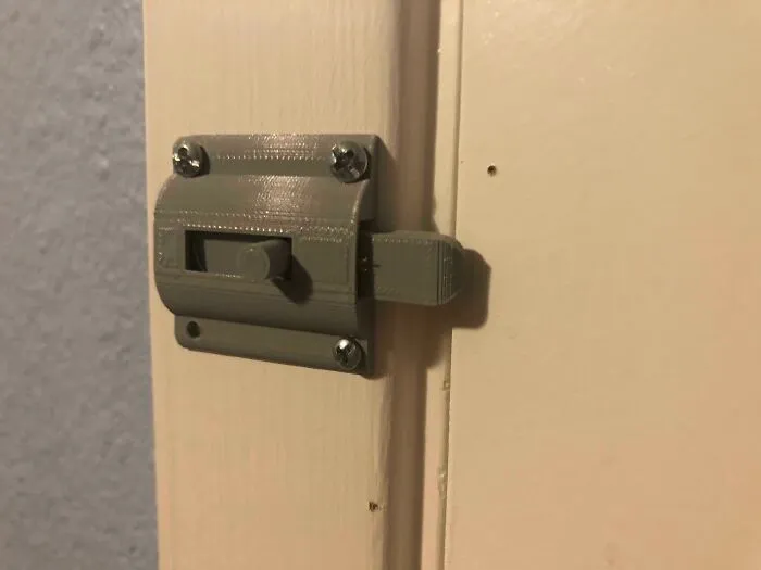 A sturdy, functional sliding door latch replacement made on a 3D printer.