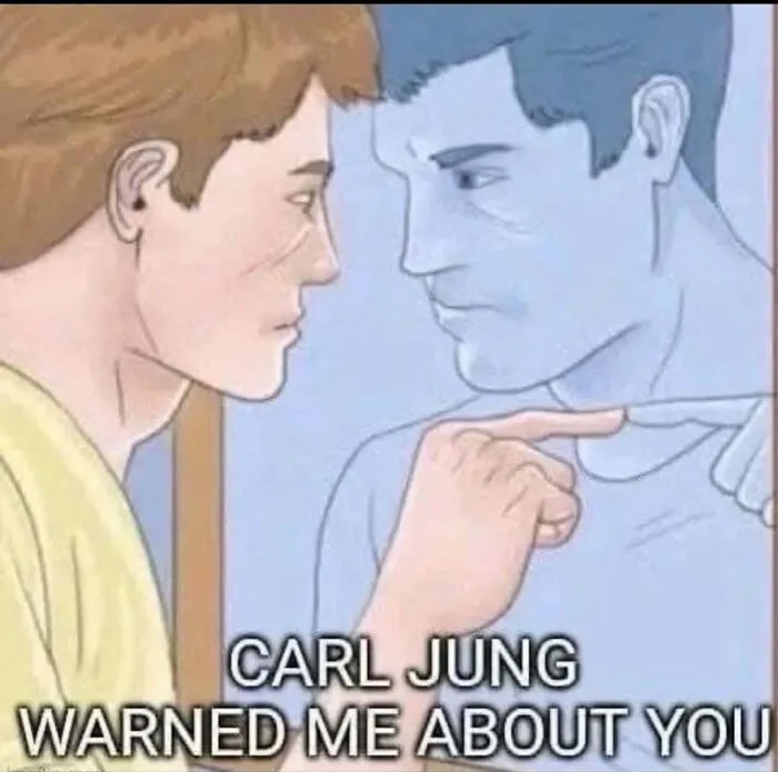 A psychology-themed relatable meme showing a man looking in the mirror with a Carl Jung caption.