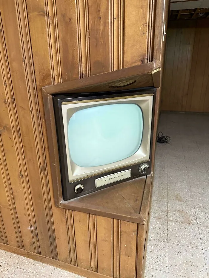 Vintage RCA Victor television built into wood paneling demonstrating classic retro gadgets