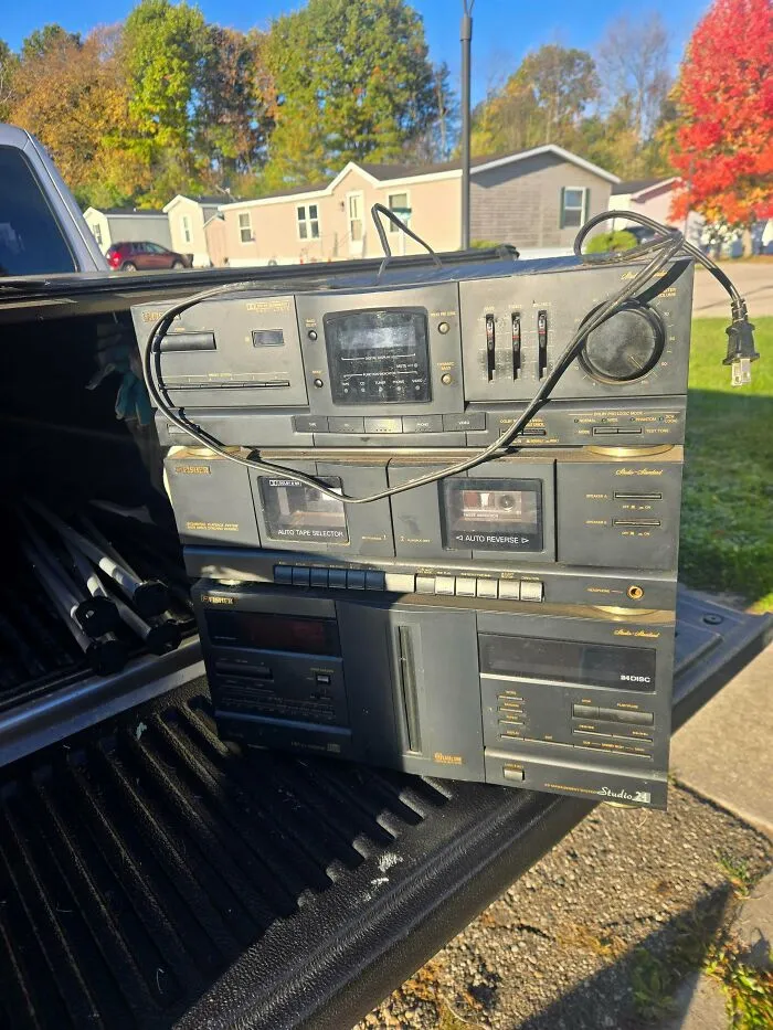 Stacked black Fisher stereo system components showcasing retro gadgets technology in a truck bed