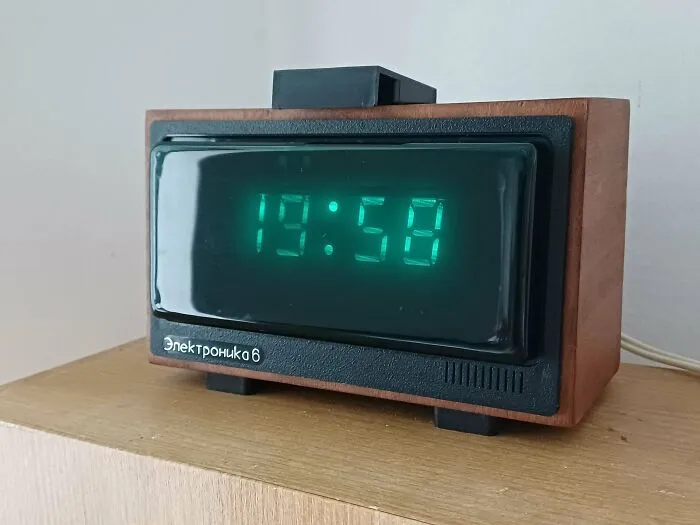 A vintage Elektronika 6 digital clock with glowing green numbers, highlighting retro gadgets design.