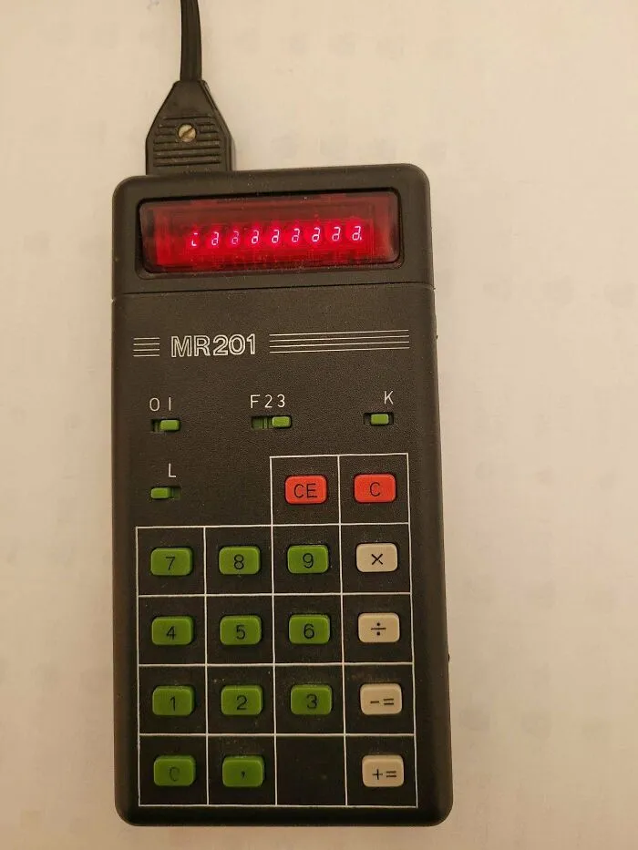 Vintage MR201 electronic calculator displaying red numbers, showing classic design in retro gadgets.