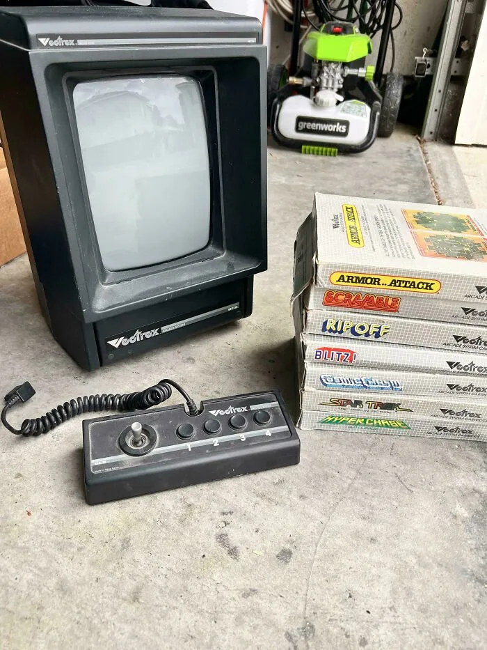 Classic Vectrex arcade gaming console with controller and game boxes, representing iconic retro gadgets.