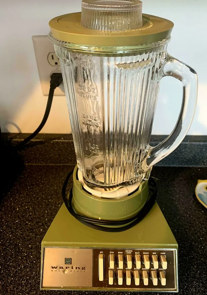 A vintage green Waring blender representing classic retro gadgets on a kitchen counter.