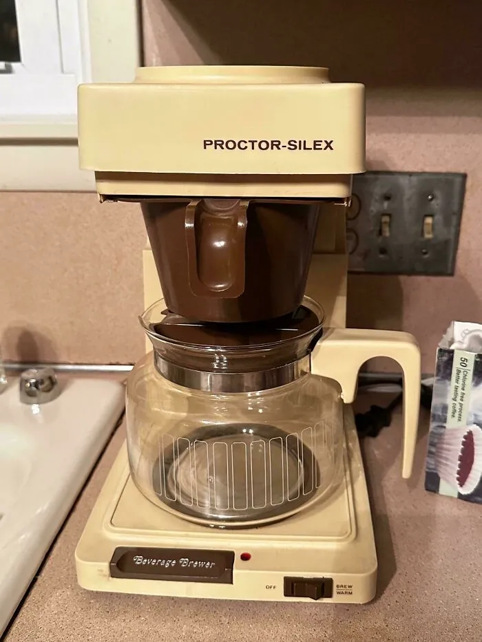 A classic beige Proctor-Silex coffee maker displayed as one of many timeless retro gadgets.