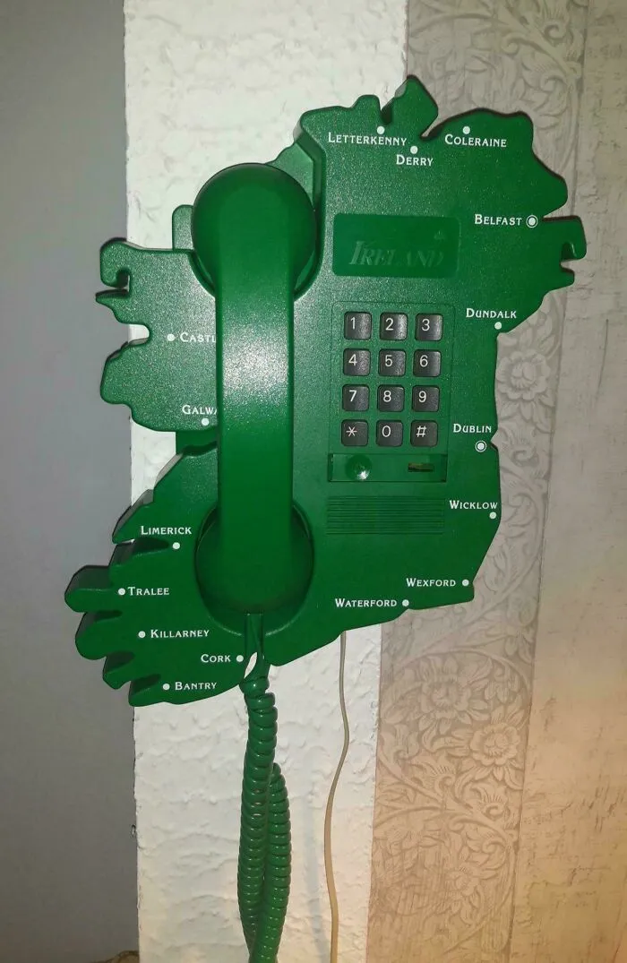 A green wall-mounted landline phone shaped like Ireland, showcasing unique retro gadgets technology