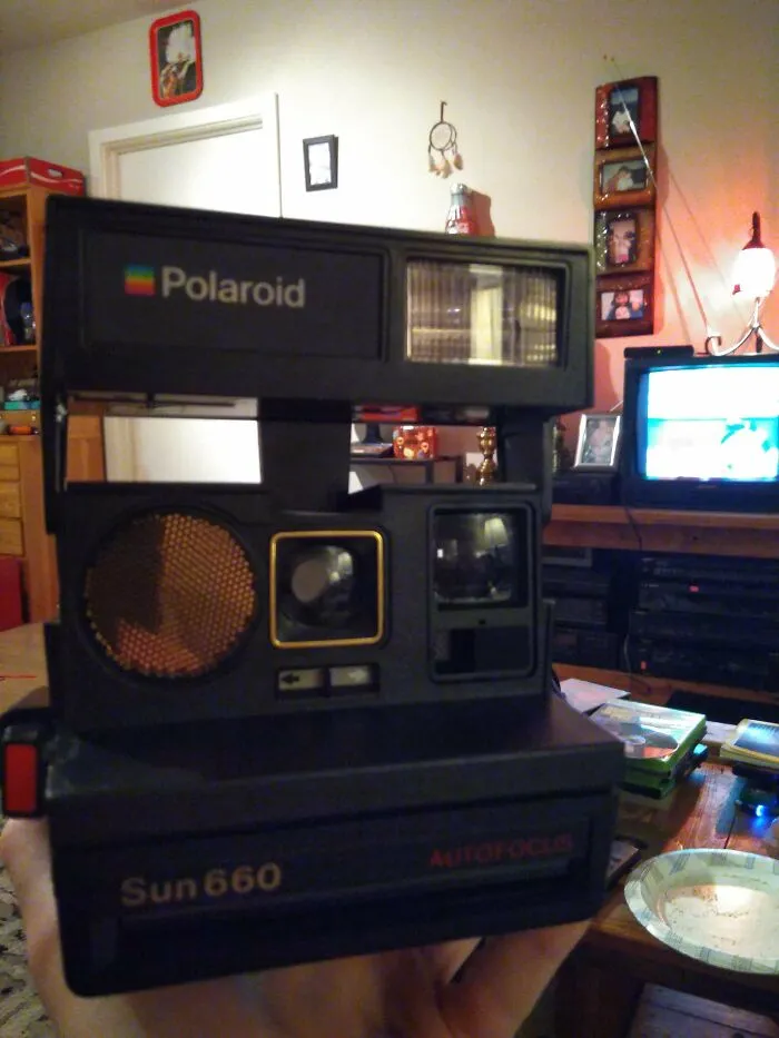 A black Polaroid Sun 660 instant camera showcasing classic retro gadgets technology design