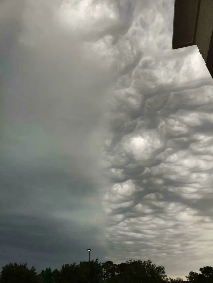 A strange photo showing a cloud formation divided perfectly in half down the middle of the sky.