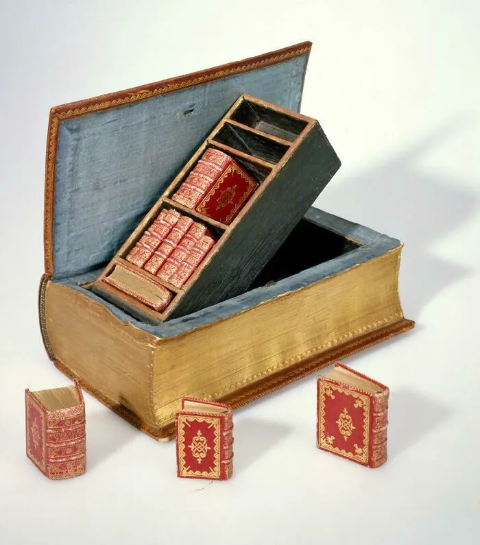 Unique discovery of miniature red books inside a hollow large book artifact