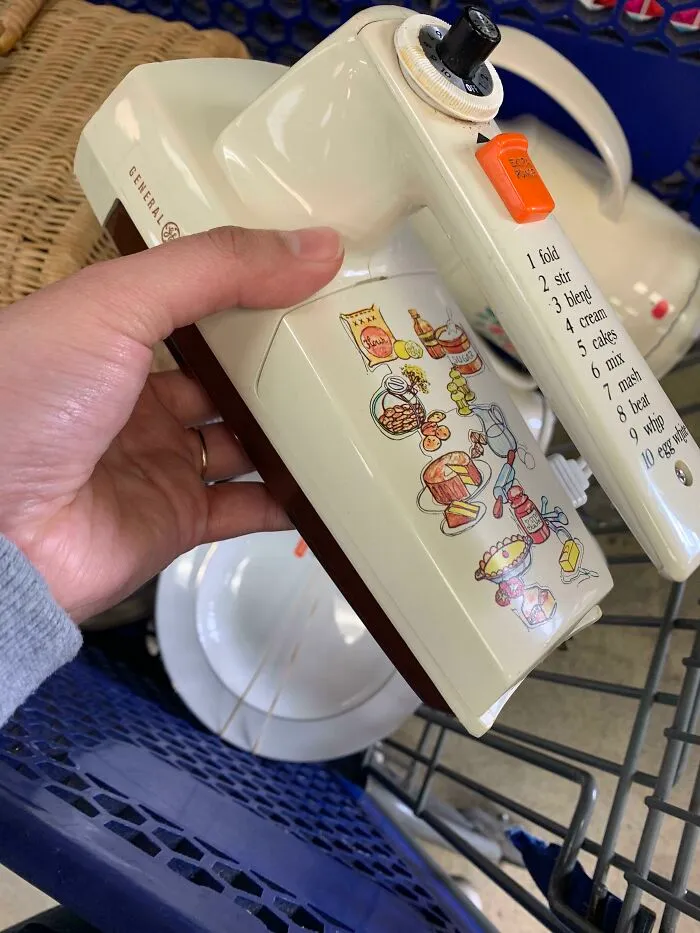 Hand held vintage electric mixer showing retro gadgets with illustrated speed guide settings
