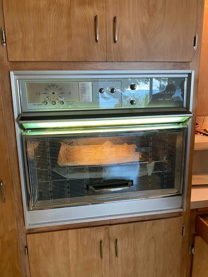 Vintage Frigidaire wall oven, an example of retro gadgets built into wooden kitchen cabinetry