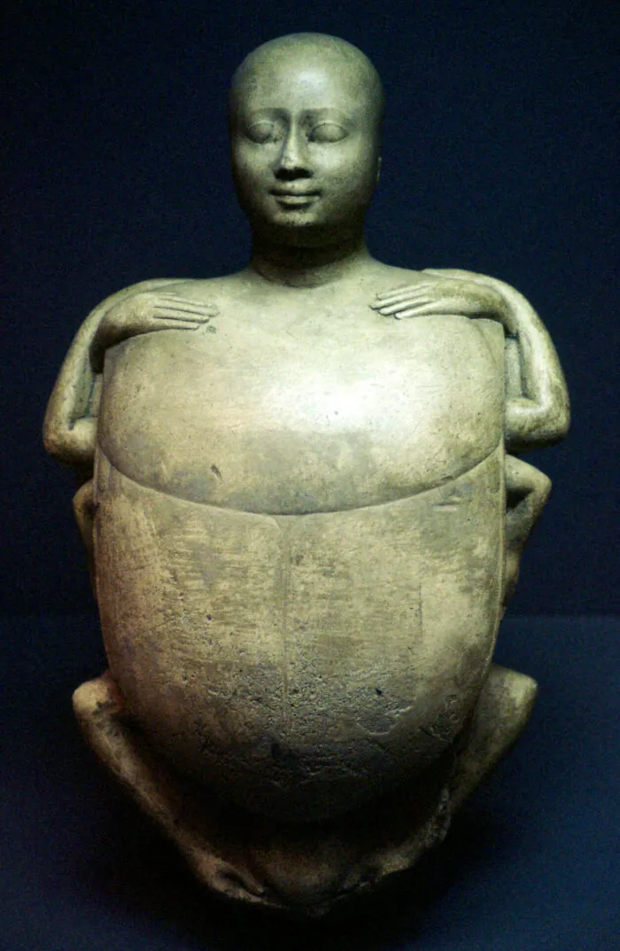 Creepy ancient stone sculpture showing a human figure with extra limbs