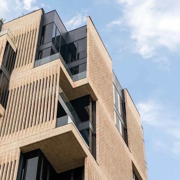 Modern building design with textured slatted beige facade panels, a unique architectural masterpiece