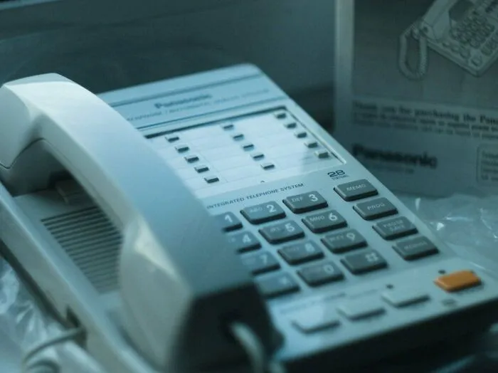Close up of an off white Panasonic landline telephone showing retro gadgets design