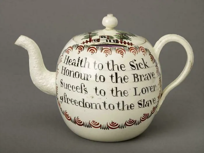 Antique teapot with painted inscription and decorative design artifact