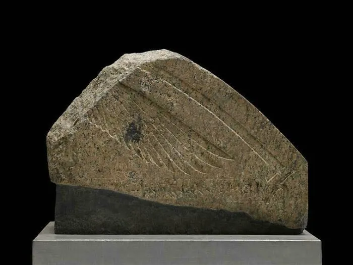 Ancient stone artifact with engraved wing design from strange discoveries