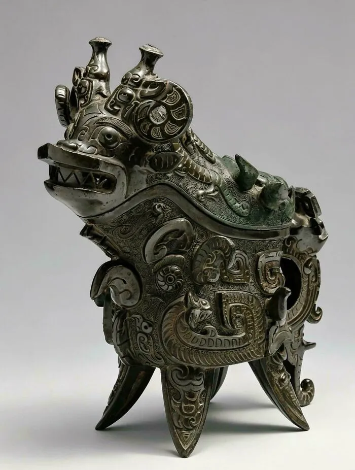 Ancient bronze artifact with intricate dragon design and patterns