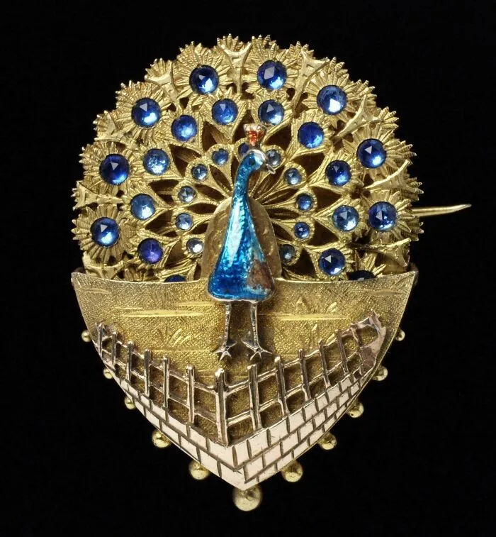 Vintage peacock brooch with blue gemstones and gold metalwork