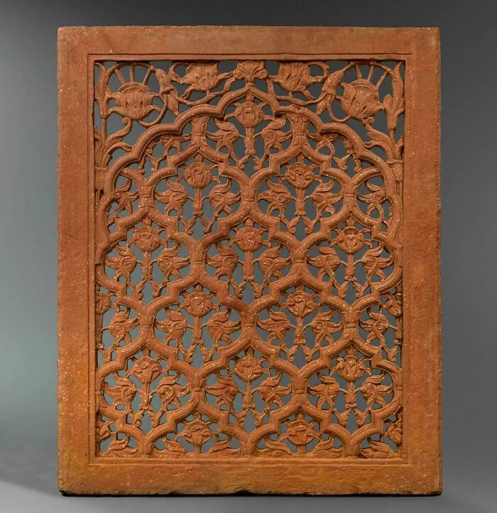 Intricately carved terracotta panel with floral design artifact