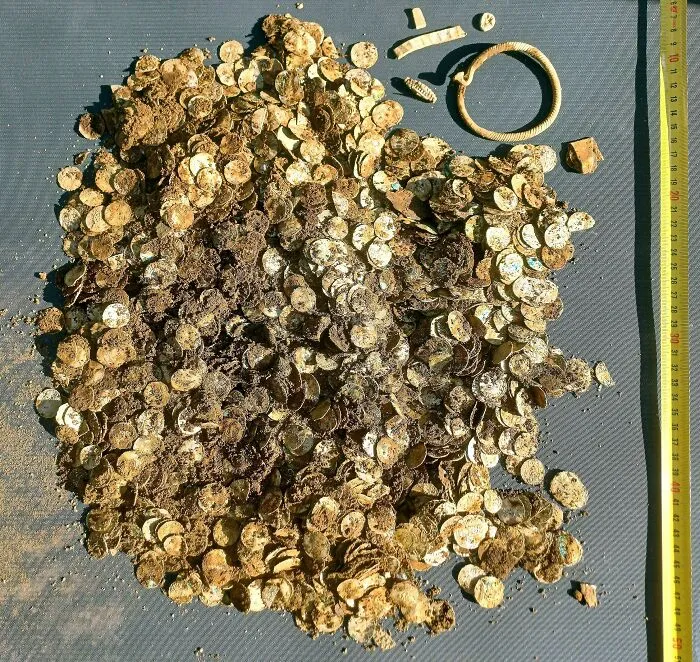 Pile of ancient gold coins and artifacts from a historic treasure discovery