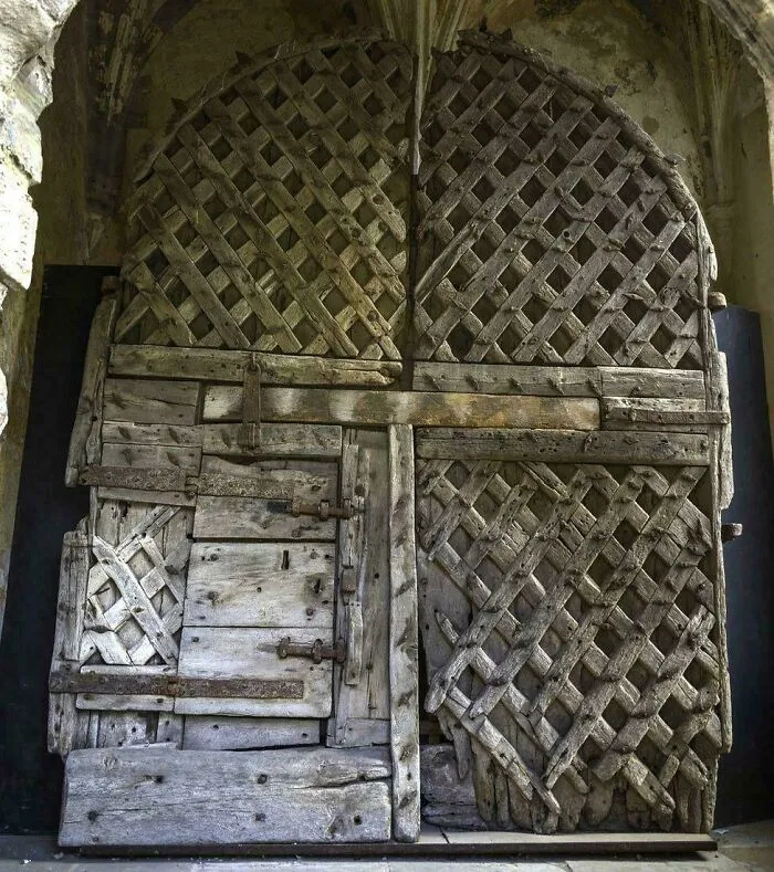Old wooden lattice antique door with intricate weathered design from interesting artifacts