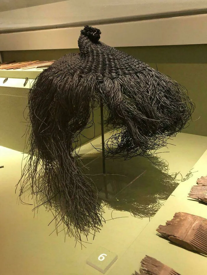 Intricately woven black traditional hairpiece or garment