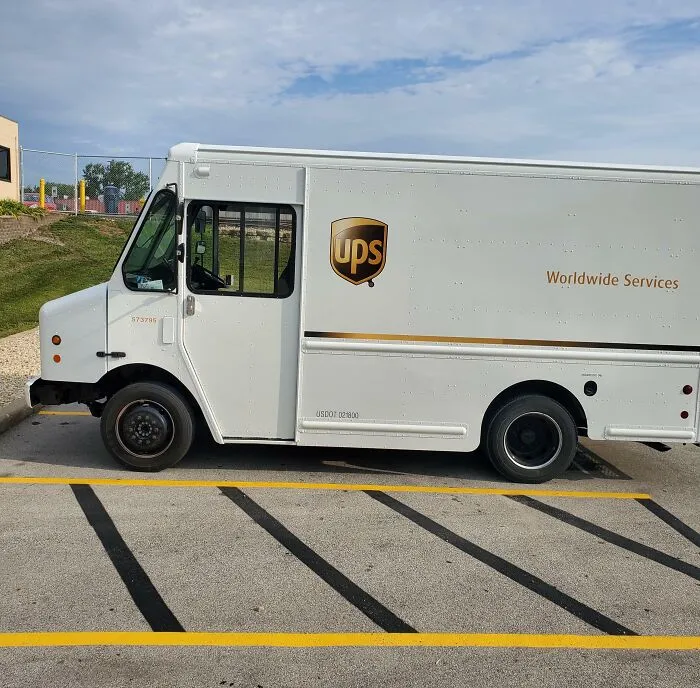 A rare all-white UPS delivery truck parked in a lot, capturing strange photos of real-life anomalies.