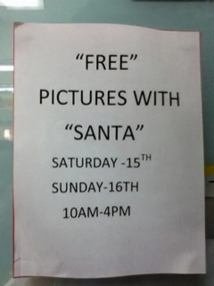 Printed sign for free pictures with Santa with misused quotation marks on key words.