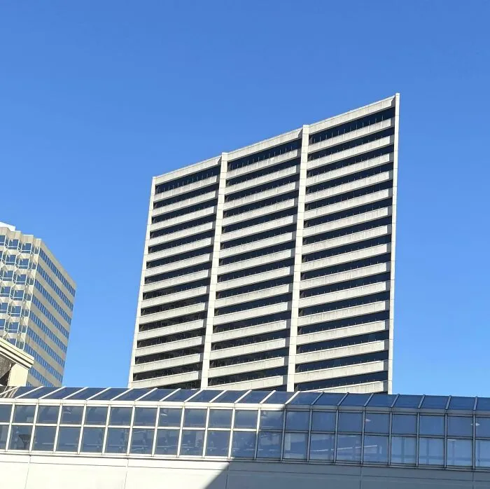 A optical illusion skyscraper that appears completely flat from this angle, looking like a strange photo.