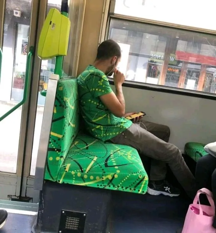 Strange photos of a passenger wearing a green shirt that perfectly matches the bus seat pattern