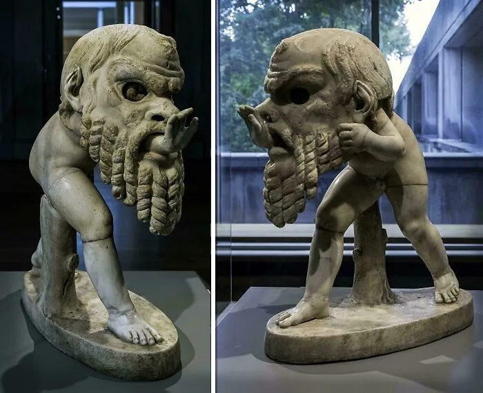 Unusual ancient stone sculpture with large head and muscular body