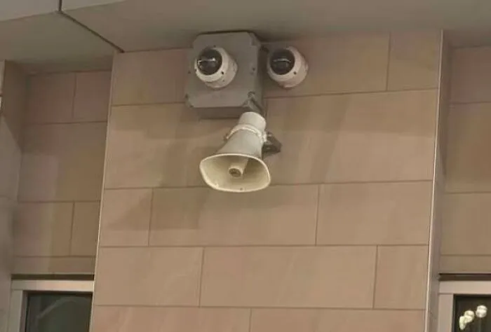 Wall security cameras and a speaker resembling a face