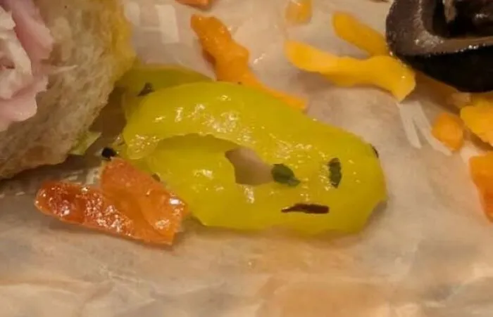 Yellow pepper slice with markings resembling a staring face