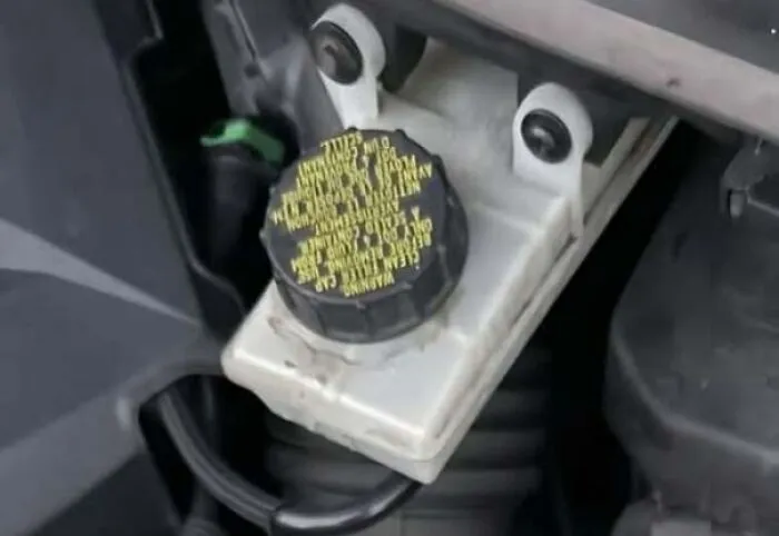 Car engine part resembling a face staring with two bolts like eyes