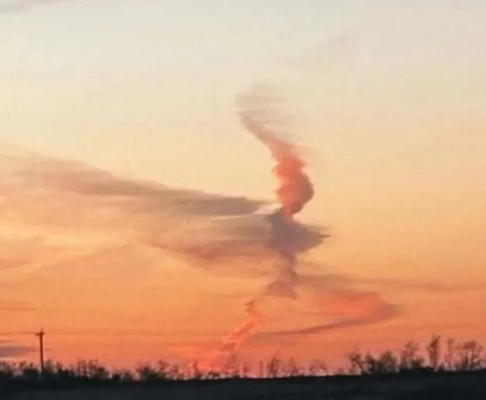 Sunset clouds forming a shape like a figure staring.