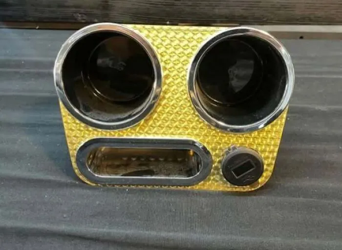 Car cup holder and ashtray combo resembling a staring face