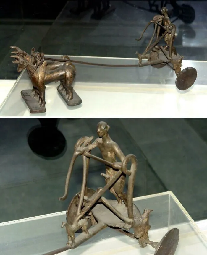 Ancient bronze chariot artifact with horse and driver sculpture discovery