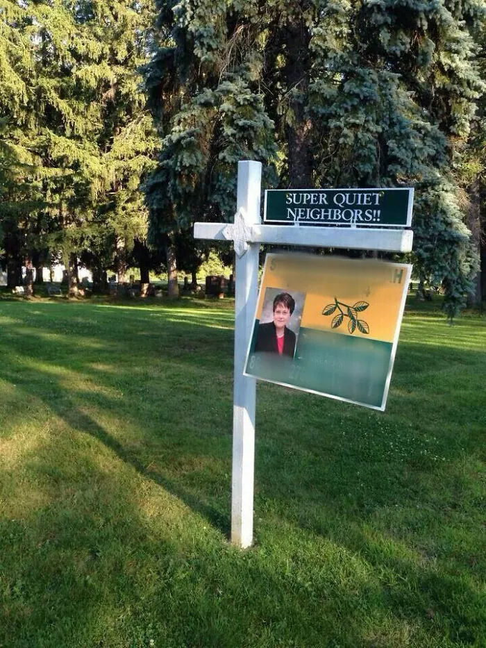 Funny real estate sign advertising super quiet neighbors next to a graveyard.
