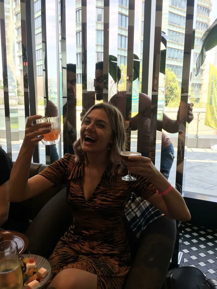 A man makes a funny face in a mirror wall reflection, a photo hijacked by the background