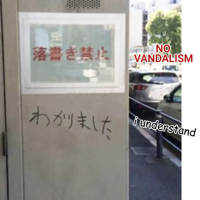 A hand-written reply under a sign in an act of vandalism
