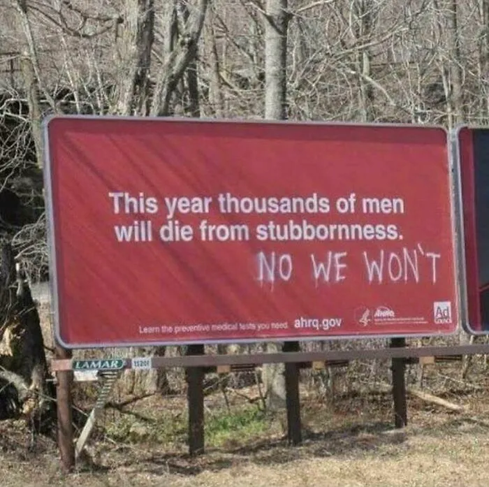 An ad billboard about stubbornness modified with a humorous graffiti reply, an act of vandalism as public art.