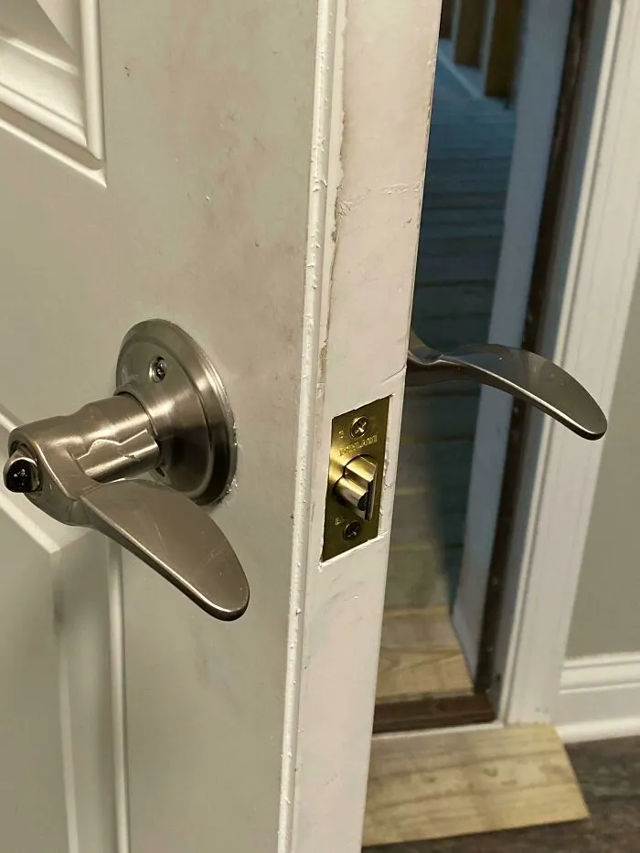 A backwards installed door handle showing a bad home renovation job.