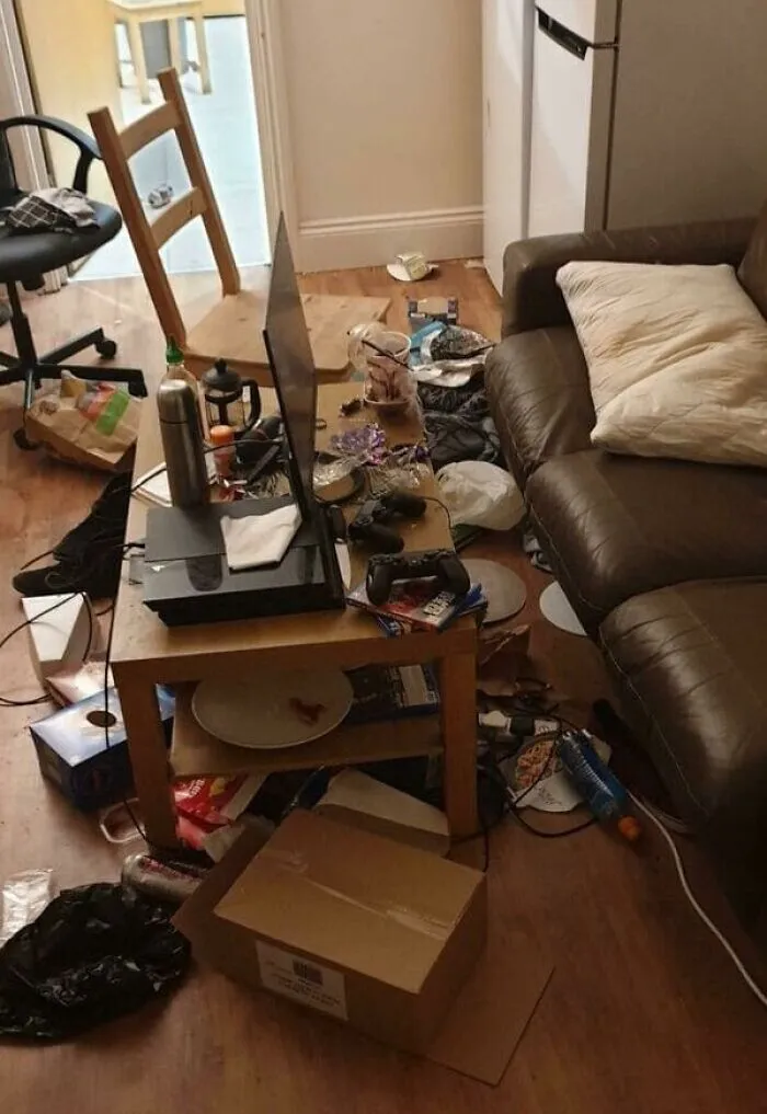 A messy living room with trash and clutter everywhere, representing bad roommate stories.