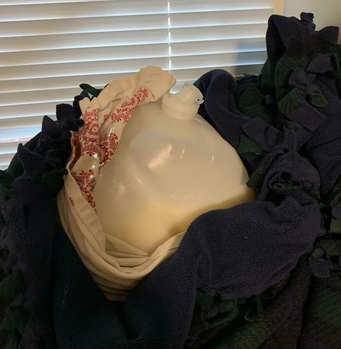 A milk jug wrapped in a shirt and blanket, illustrating weird roommate stories.