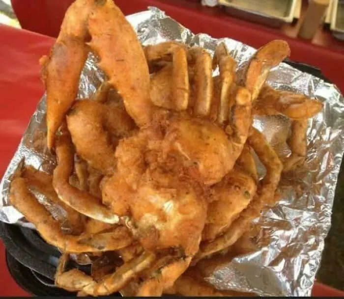 Deep fried whole crab served on foil as one of many questionable food combos.